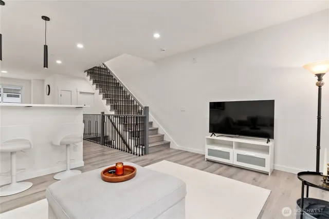 a view of a hallway with wooden floor and entryway