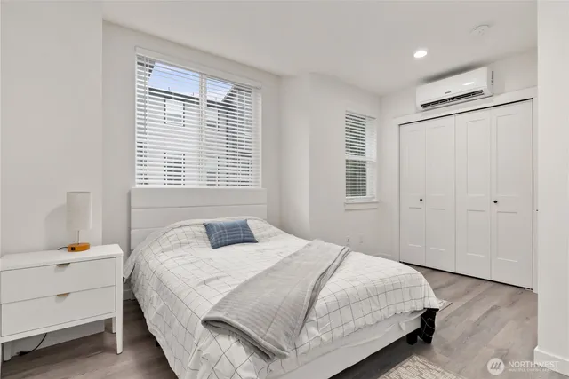 a view of a hallway with closet and wooden floor
