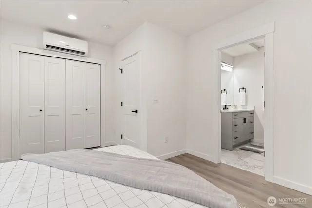 a view of room with walk in closet with wooden floor