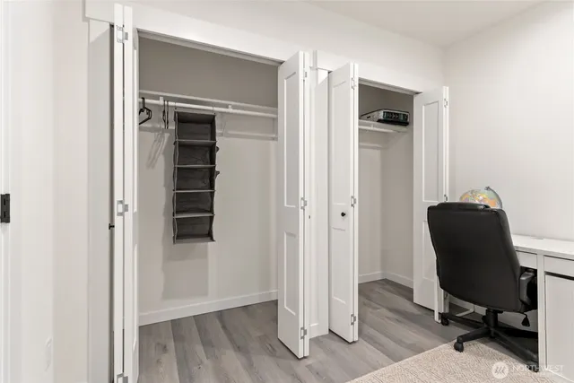 a view of walk in closet with empty racks