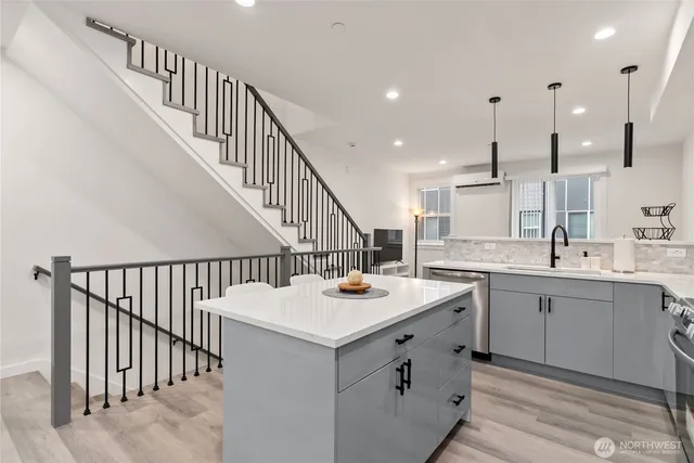 a kitchen with stainless steel appliances a refrigerator stove microwave and cabinets