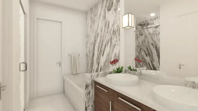 a bathroom with a granite countertop sink a toilet and shower