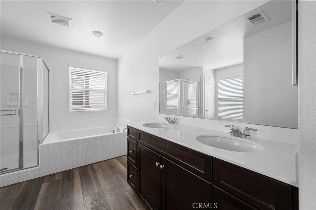 893 Harvest Avenue Upland, CA 91786 - Photo 16 of 40 a bathroom with a tub sink double vanity granite and a bathtub
