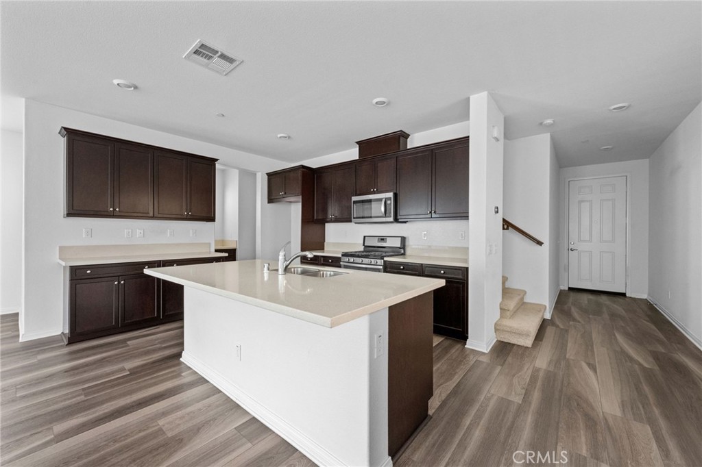 893 Harvest Avenue Upland, CA 91786 - Photo 3 of 40 a kitchen with stainless steel appliances granite countertop a sink stove and refrigerator
