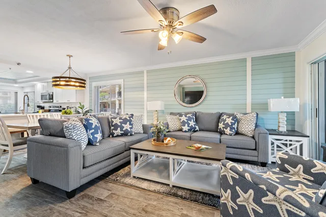 a bedroom with a bed and large windows