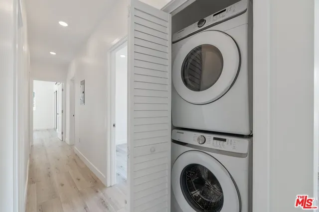 a view of a hallway with washer and dryer