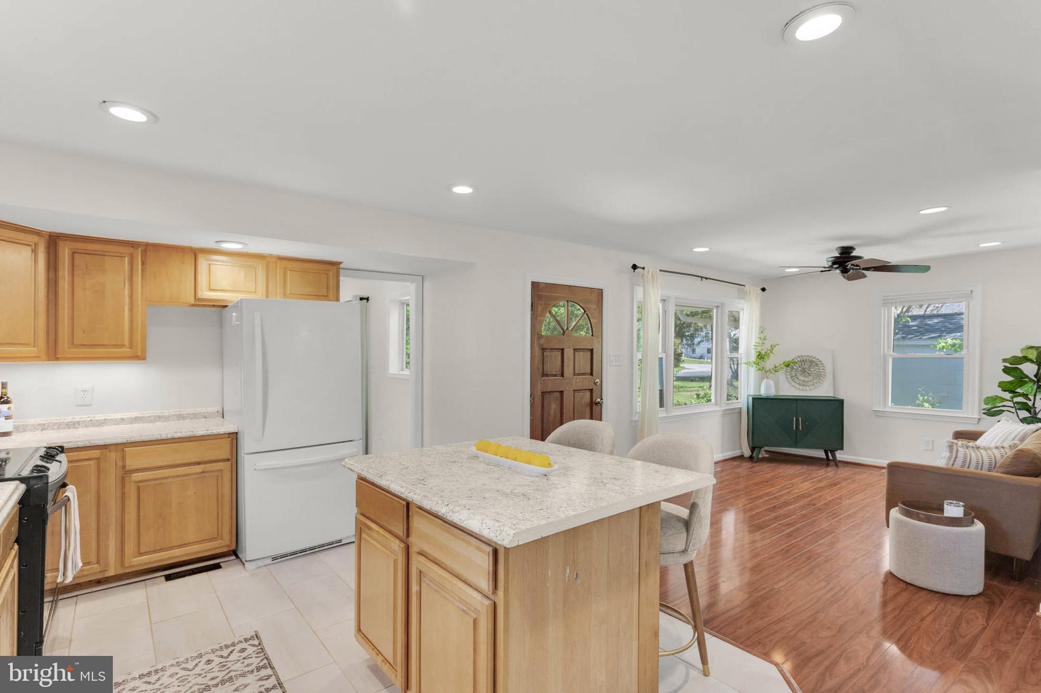 1502 Grange Road Edgewater, MD 21037 - Photo 12 of 43 a kitchen with a refrigerator a stove cabinets and living room view