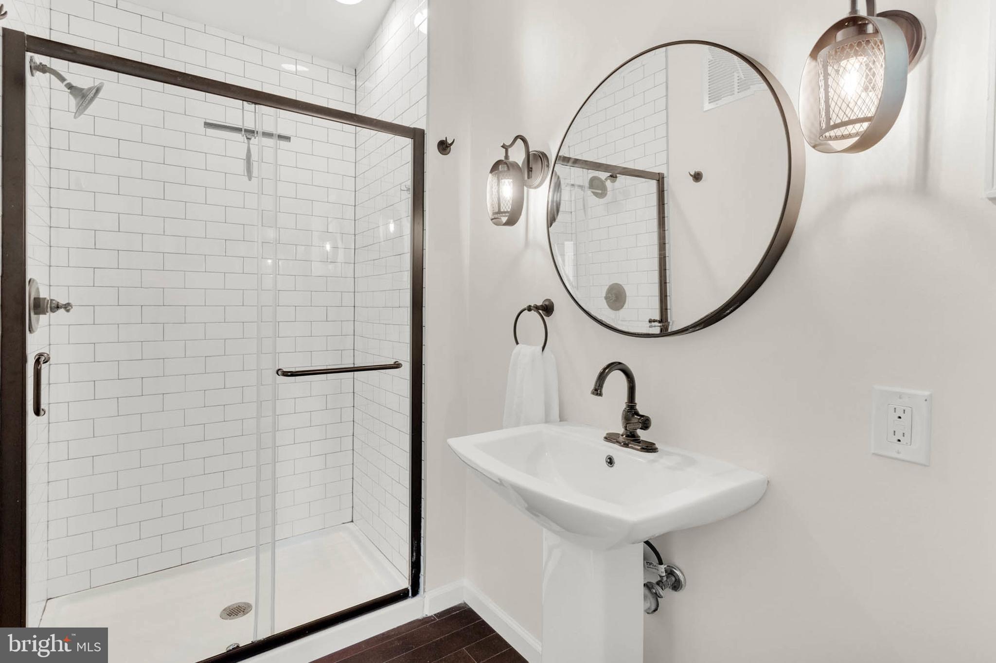 1502 Grange Road Edgewater, MD 21037 - Photo 20 of 43 a bathroom with a sink a shower and mirror