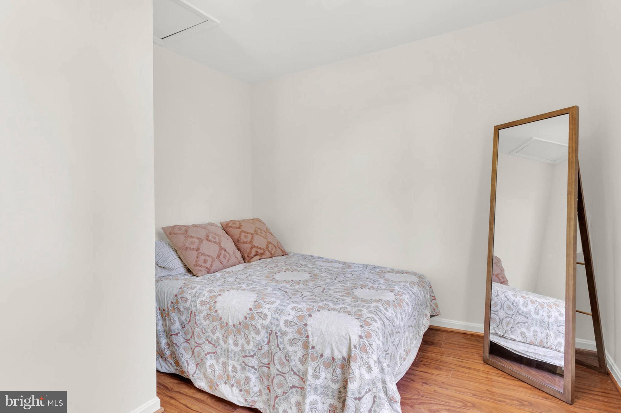 1502 Grange Road Edgewater, MD 21037 - Photo 21 of 43 a bed sitting in a bedroom next to a small window