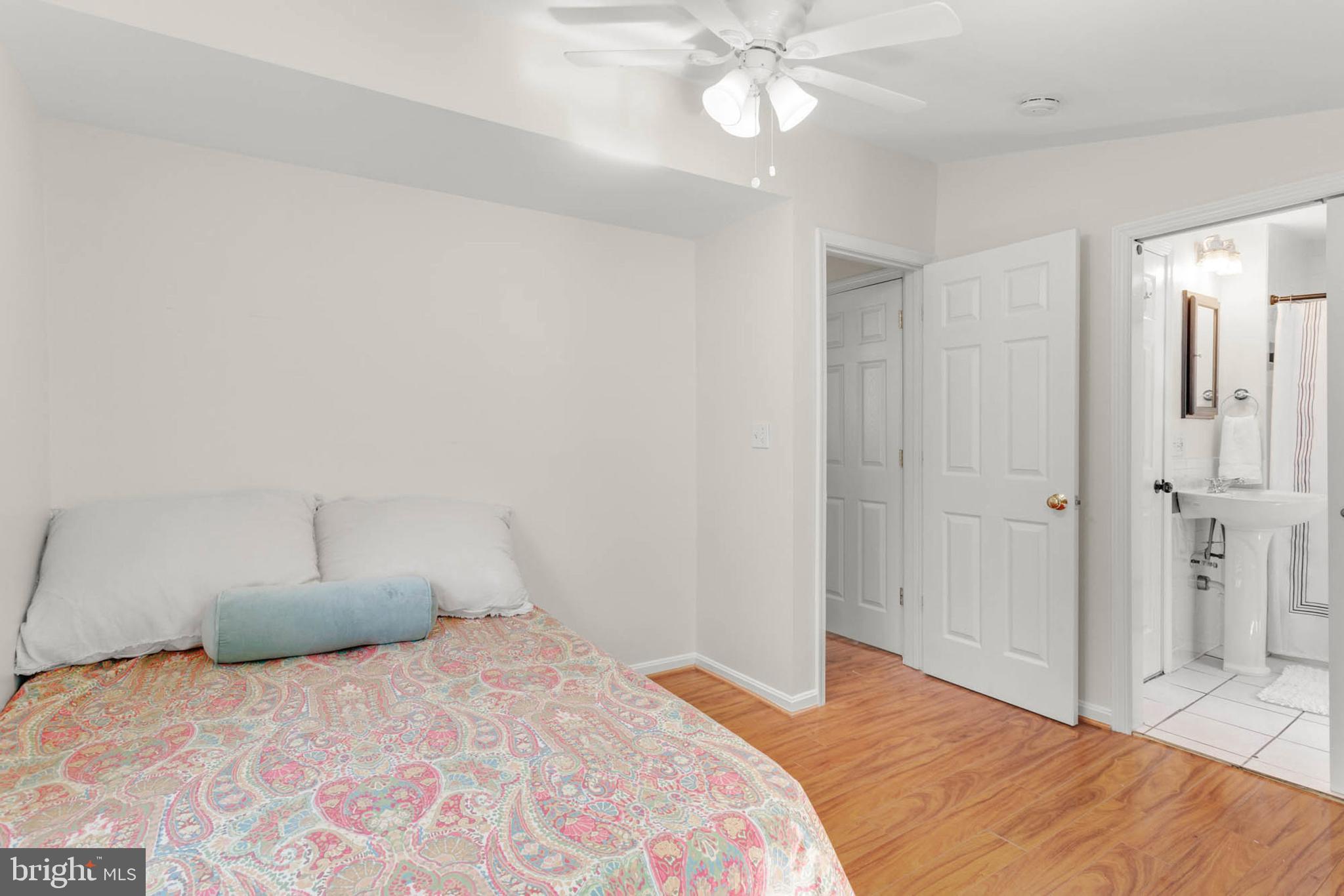 1502 Grange Road Edgewater, MD 21037 - Photo 25 of 43 a bedroom with a bed and a chandelier