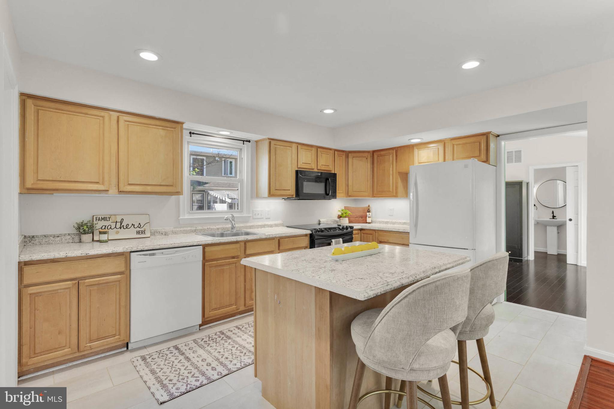 1502 Grange Road Edgewater, MD 21037 - Photo 9 of 43 a kitchen with granite countertop a sink a stove a refrigerator a center island and chairs