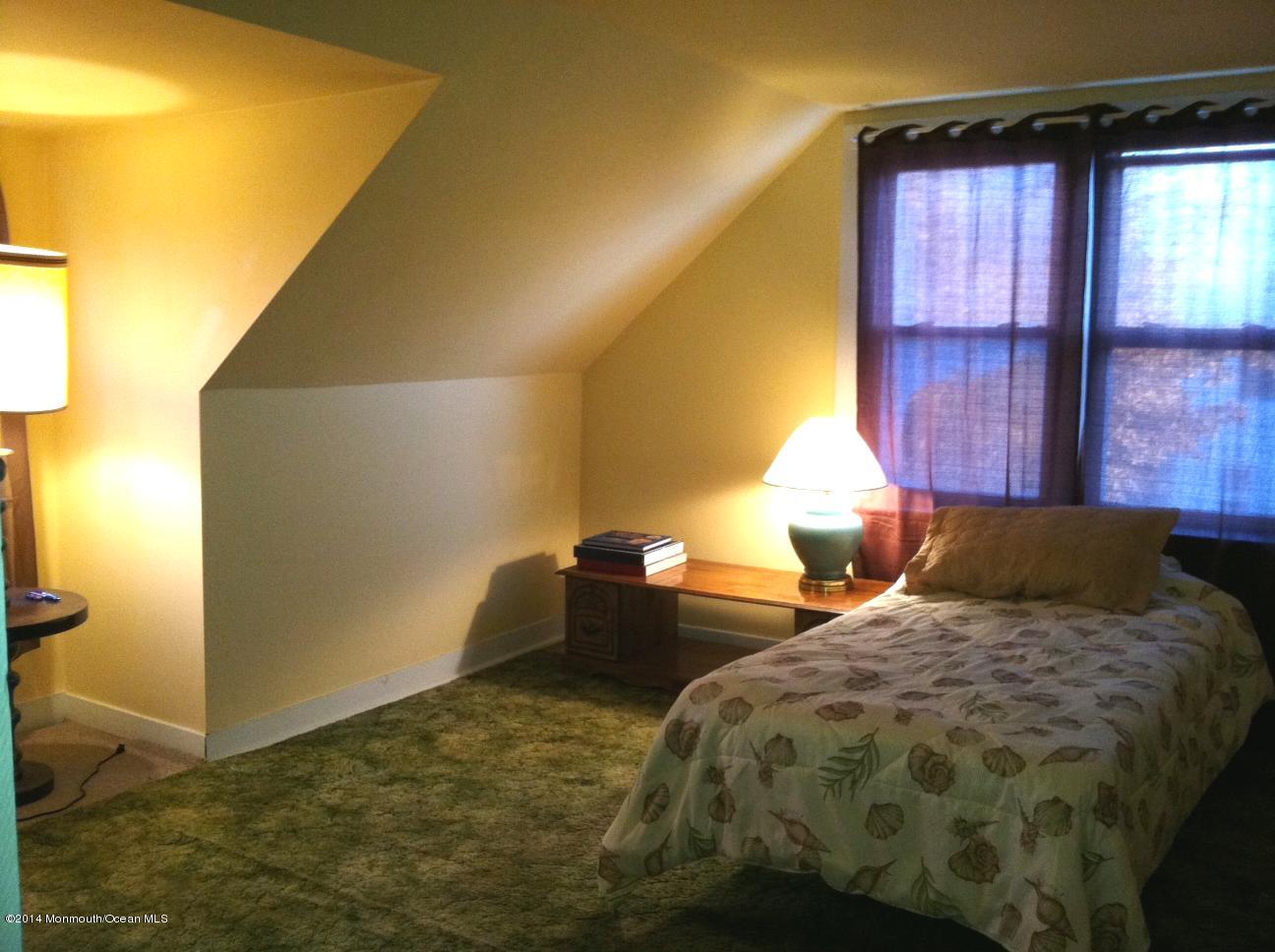 2705 Grant Street Wall, NJ 07719 - Photo 7 of 16 a bedroom with a bed and a window