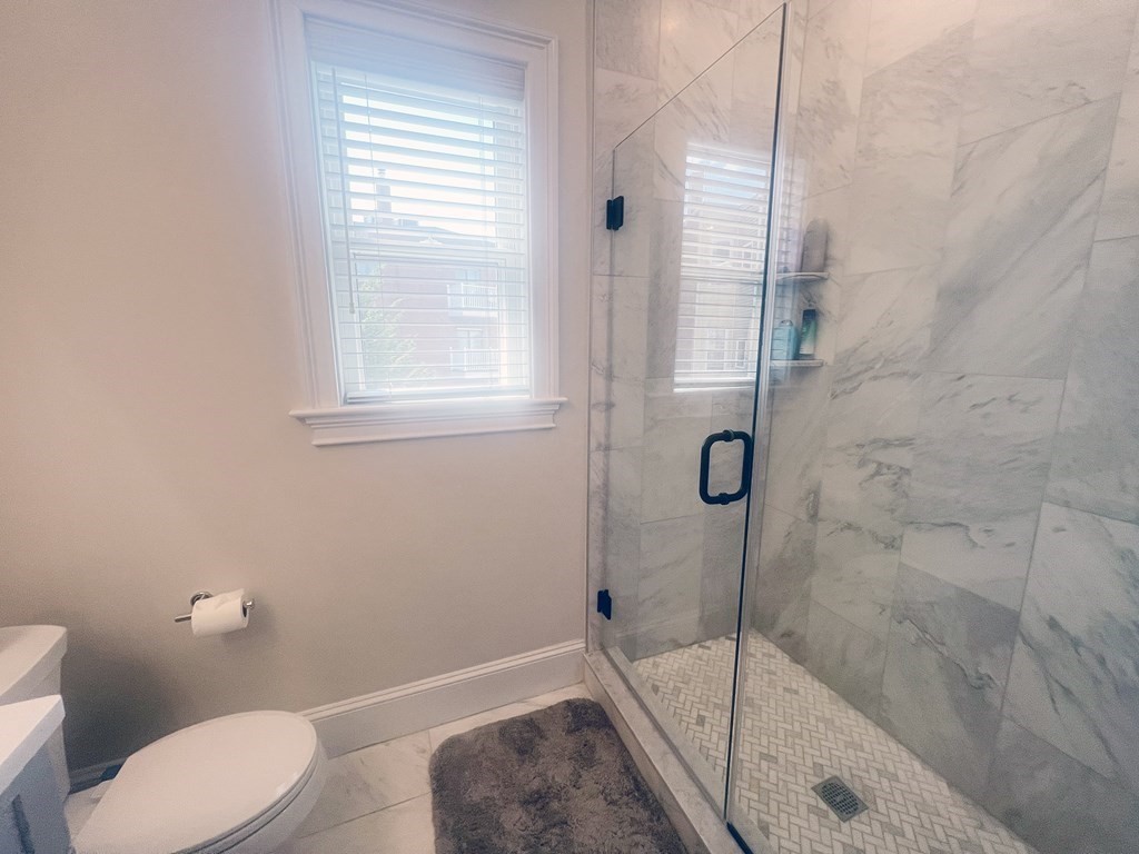 159 Bennington Street, Unit 2 Boston, MA 02128 - Photo 9 of 20 a bathroom with a toilet and shower