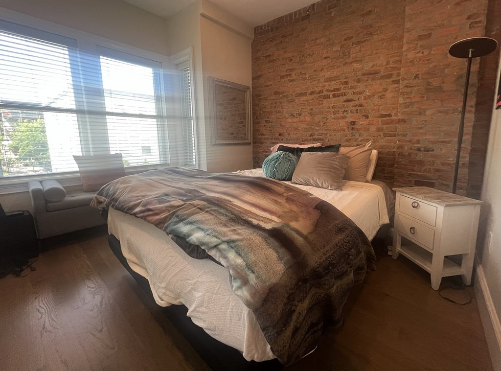 159 Bennington Street, Unit 2 Boston, MA 02128 - Photo 10 of 20 a bed sitting in a bedroom next to a window