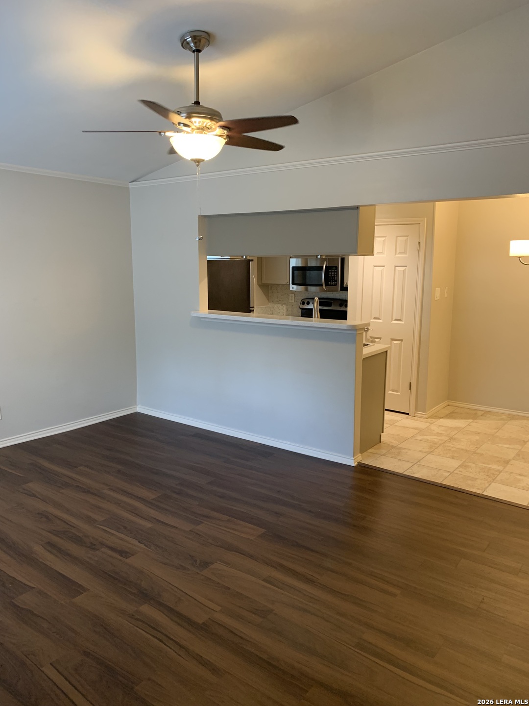 11610 Vance Jackson Road, Unit 628 San Antonio, TX 78230 - Photo 2 of 4 a view of a kitchen with a dishwasher a kitchen island wooden floor and a window