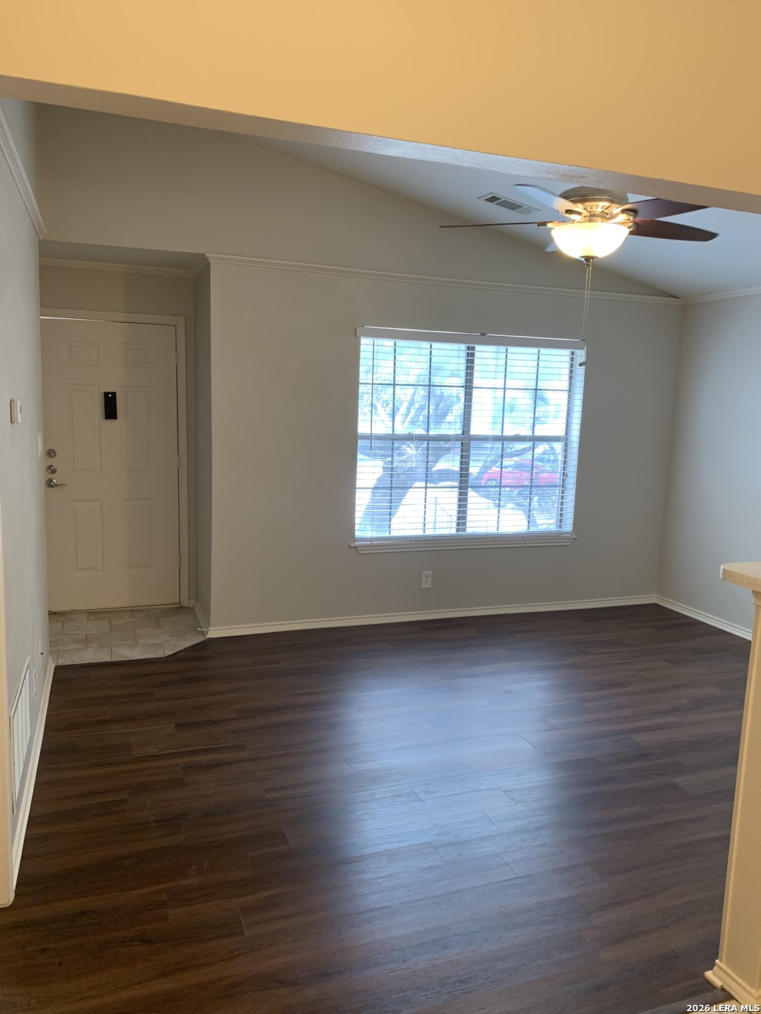 11610 Vance Jackson Road, Unit 628 San Antonio, TX 78230 - Photo 4 of 4 a view of an empty room with wooden floor and a window