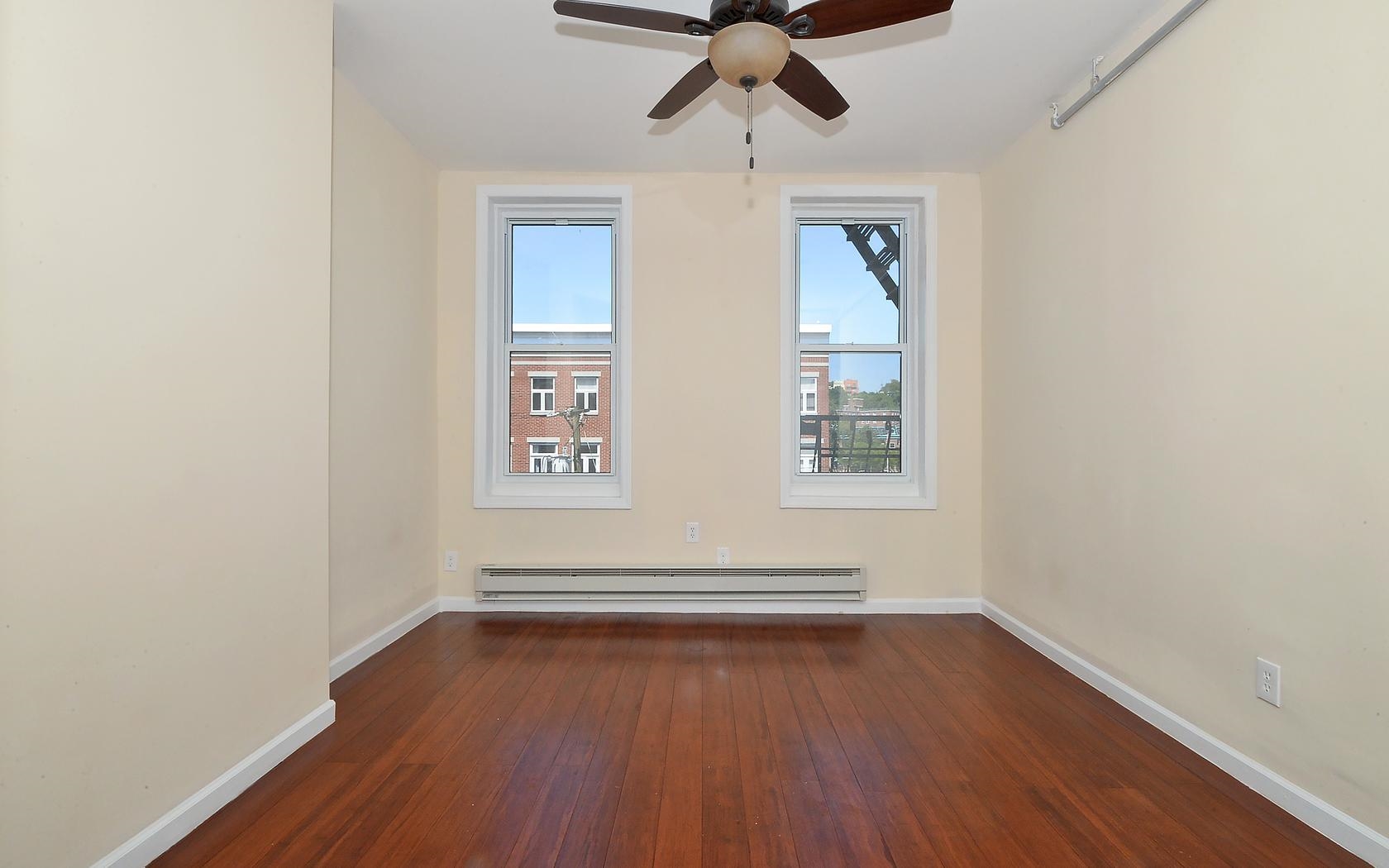 235 Monroe Street, Unit 9 Hoboken, NJ 07030 - Photo 11 of 15 wooden floor in an empty room with a window