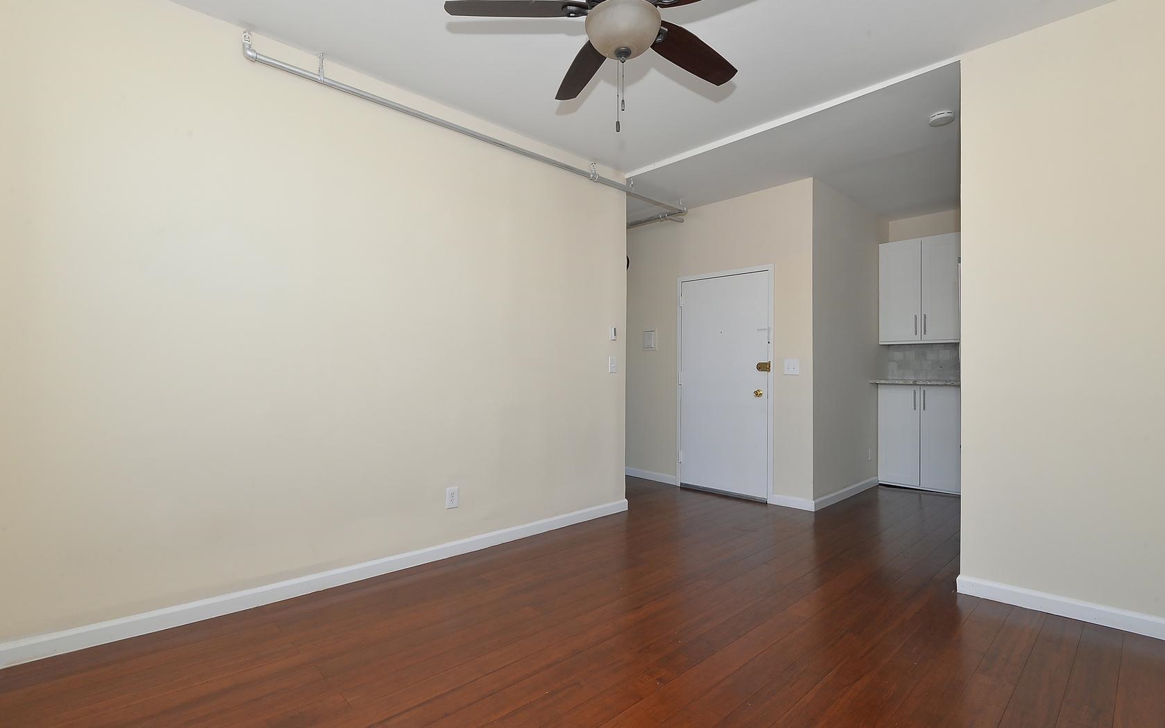 235 Monroe Street, Unit 9 Hoboken, NJ 07030 - Photo 12 of 15 a view of an empty room with wooden floor