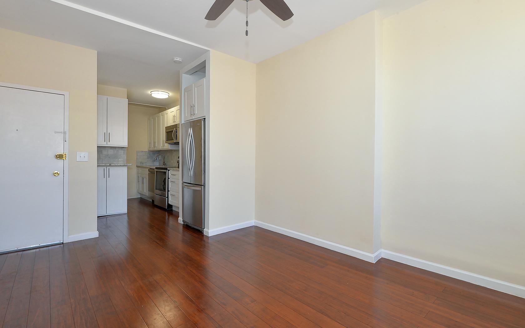 235 Monroe Street, Unit 9 Hoboken, NJ 07030 - Photo 14 of 15 a view of empty room with wooden floor and window