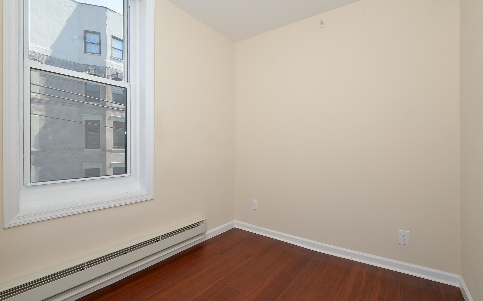 235 Monroe Street, Unit 9 Hoboken, NJ 07030 - Photo 6 of 15 a view of a small space with wooden floor and a window