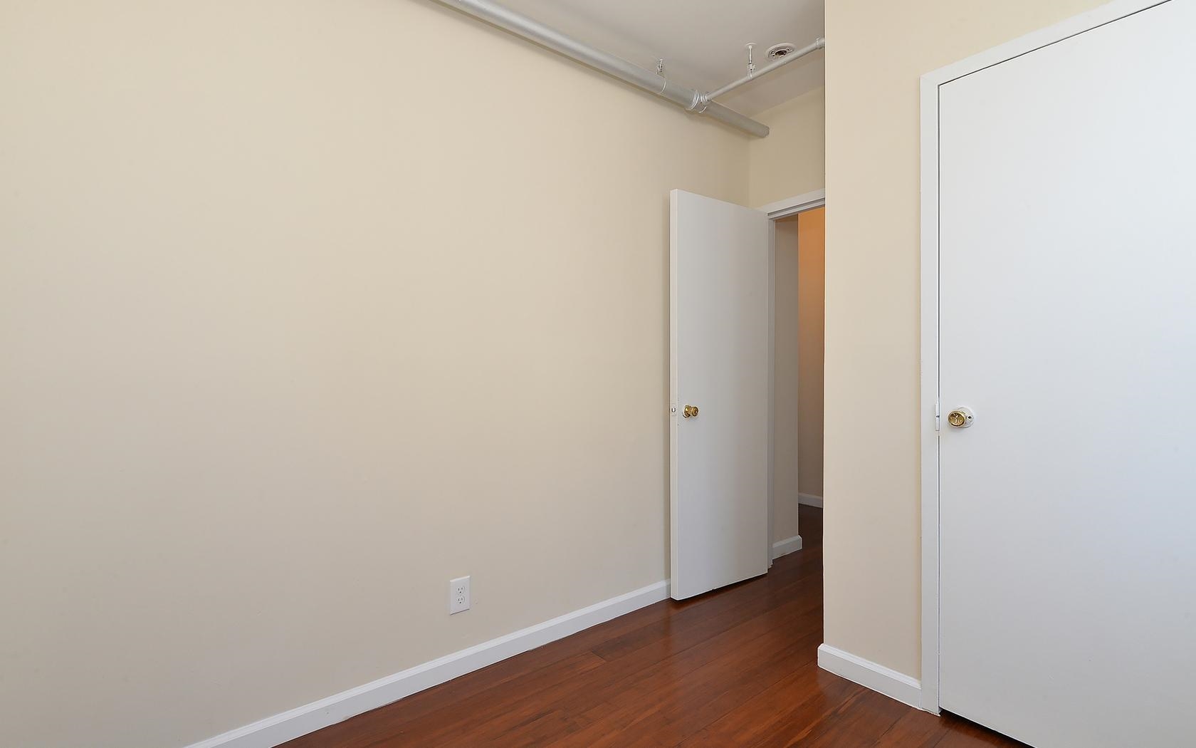 235 Monroe Street, Unit 9 Hoboken, NJ 07030 - Photo 8 of 15 a view of an empty room with wooden floor