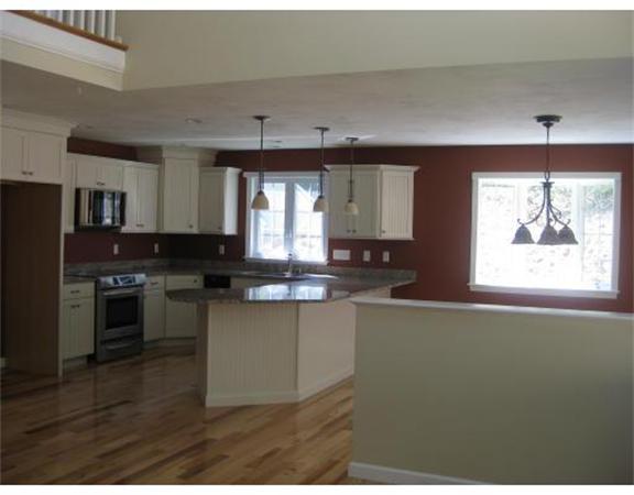 7 Reed Lane, Unit LOT 5 Littleton, MA 01460 - Photo 3 of 7 a kitchen with stainless steel appliances granite countertop a stove a sink and a microwave