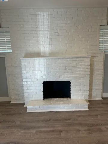 a living room with a fireplace and a fireplace