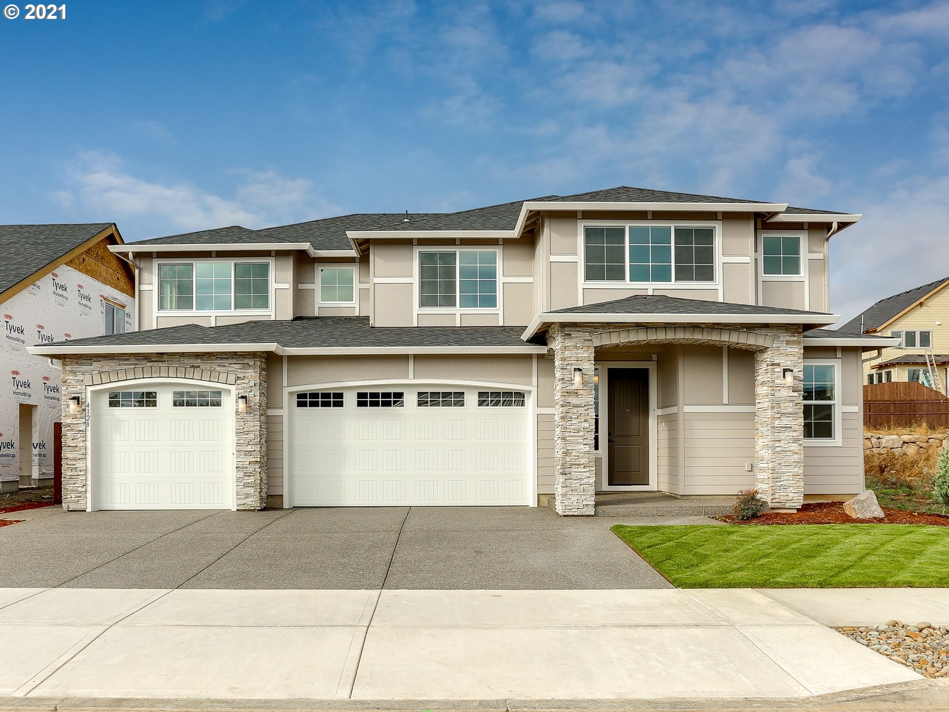 4128 South 17th Way Ridgefield, WA 98642 - Photo 1 of 21 a front view of a house with a yard and garage