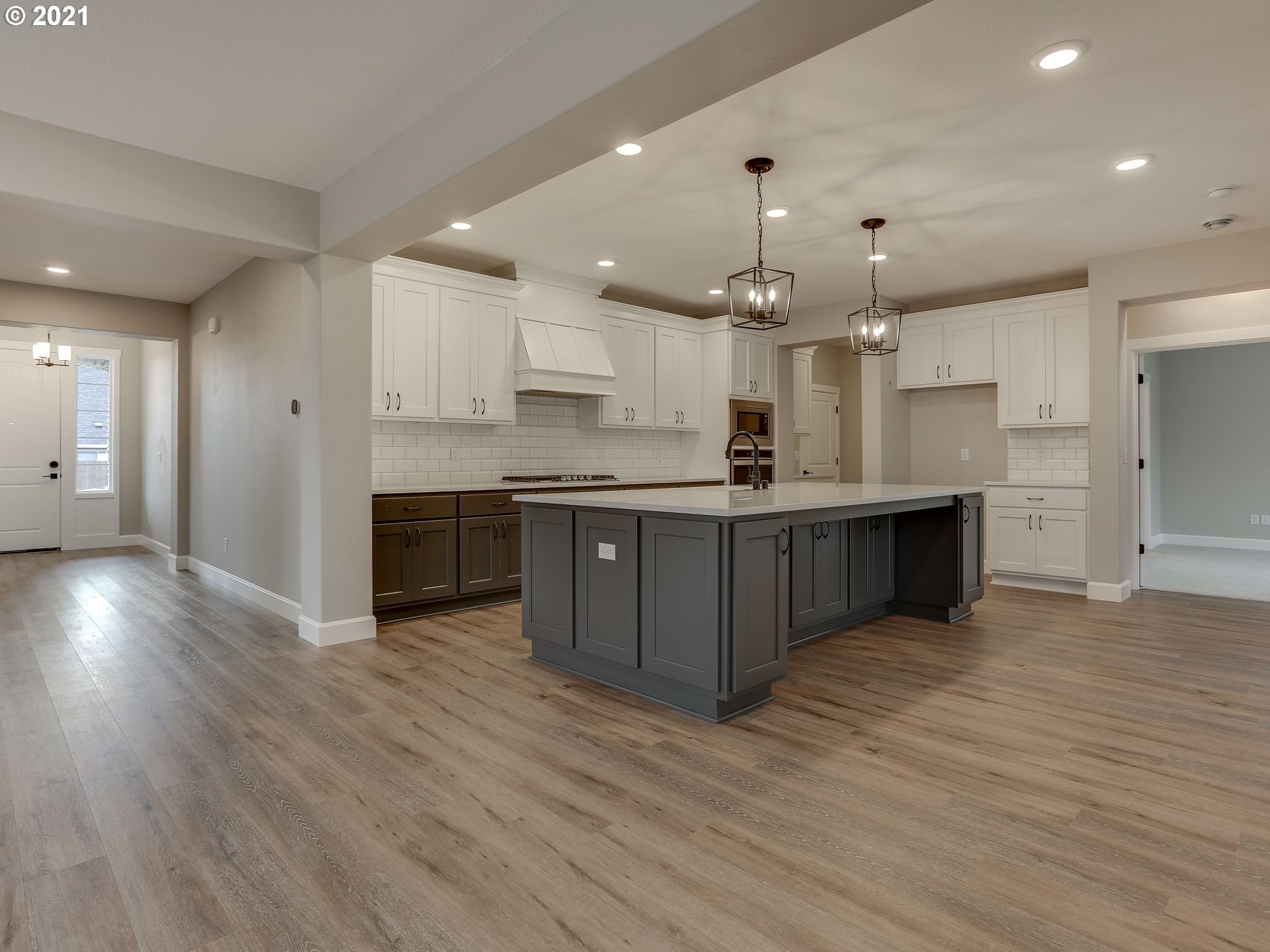 4128 South 17th Way Ridgefield, WA 98642 - Photo 7 of 21 a large kitchen with stainless steel appliances granite countertop a large counter top and wooden floors