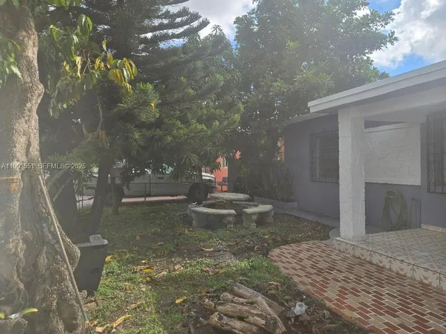 a swimming pool with yard in front of it