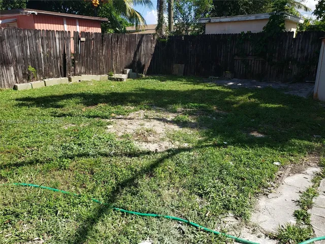 a view of backyard with wooden fences
