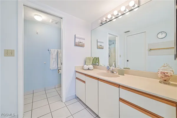 a bathroom with a sink a vanity and a mirror