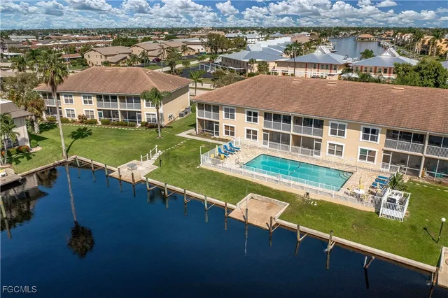 an aerial view of a house with swimming pool patio and outdoor seating