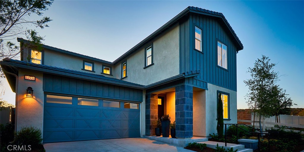 a front view of a house with lots of green space