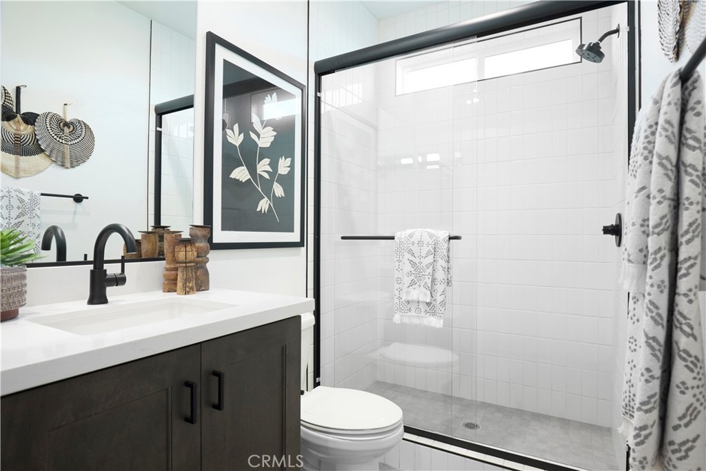 11531 Jack Street Beaumont, CA 92223 - Photo 12 of 16 a bathroom with a sink a toilet and shower