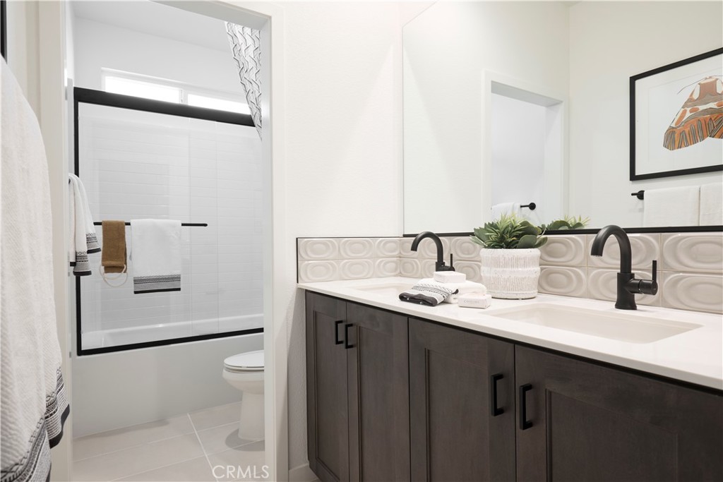 11531 Jack Street Beaumont, CA 92223 - Photo 14 of 16 a bathroom with a granite countertop sink mirror and toilet