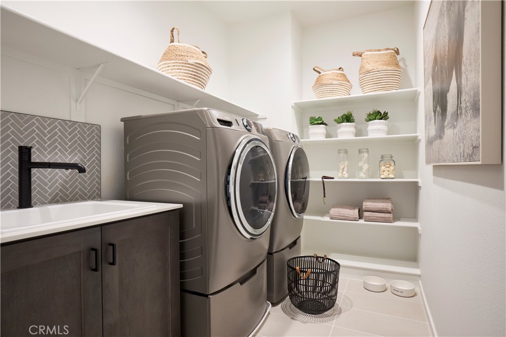 11531 Jack Street Beaumont, CA 92223 - Photo 16 of 16 a utility room with sink washer and dryer