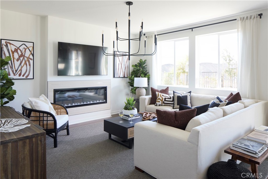 11531 Jack Street Beaumont, CA 92223 - Photo 3 of 16 a living room with furniture a flat screen tv and a fireplace