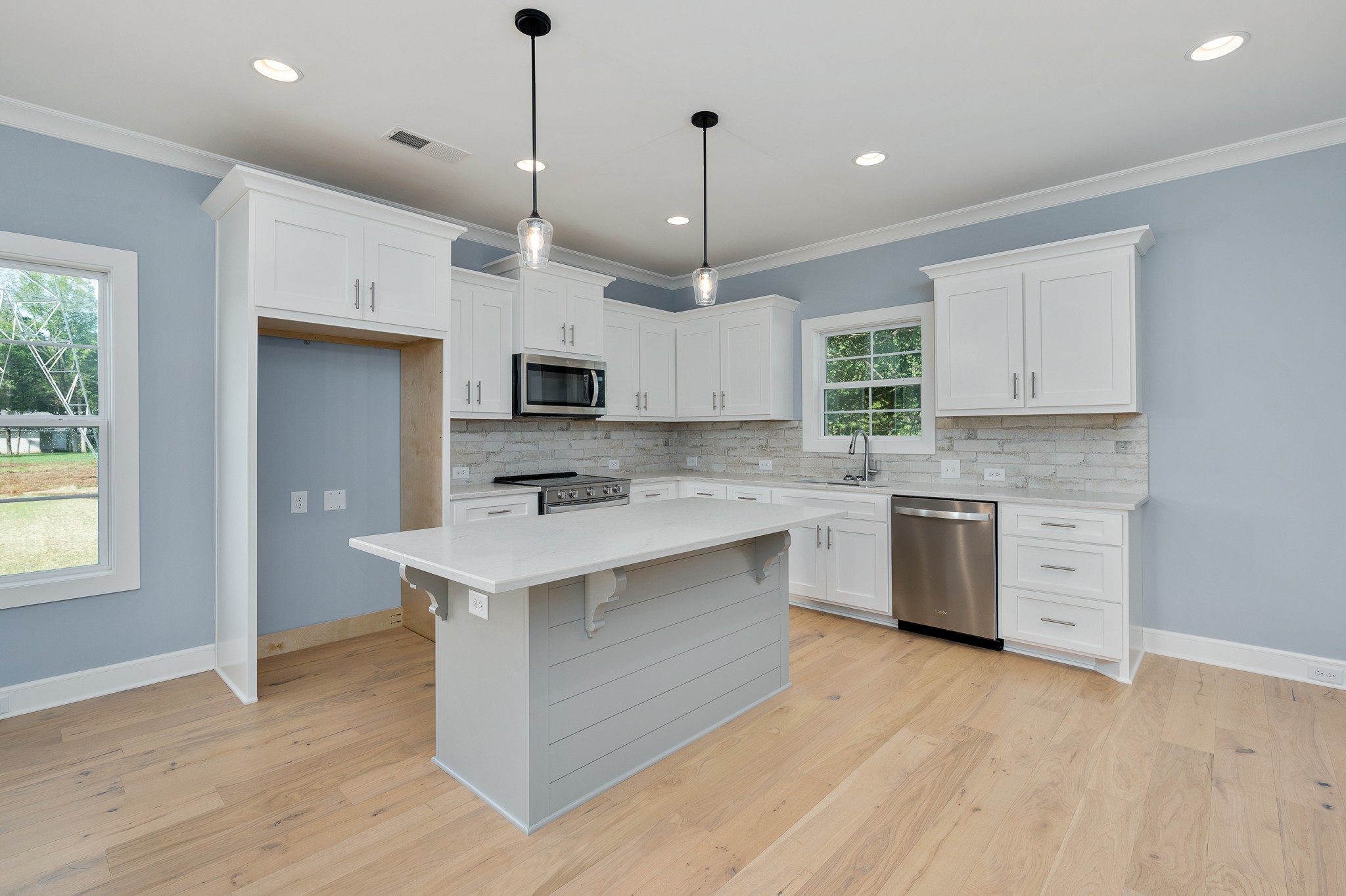 6720 Murfreesboro Road Lebanon, TN 37090 - Photo 8 of 28 a large kitchen with stainless steel appliances granite countertop a sink a stove a refrigerator and island with wooden floor