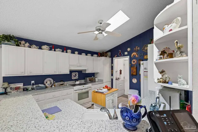 a kitchen with a sink cabinets and window