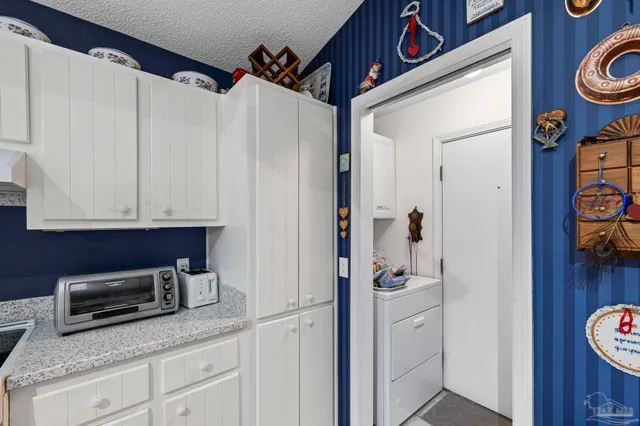 a kitchen with a white cabinets and white appliances