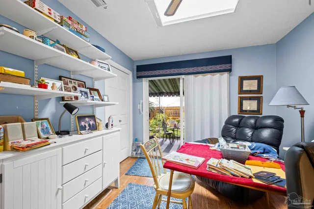 a living room with furniture gym equipment and a rug