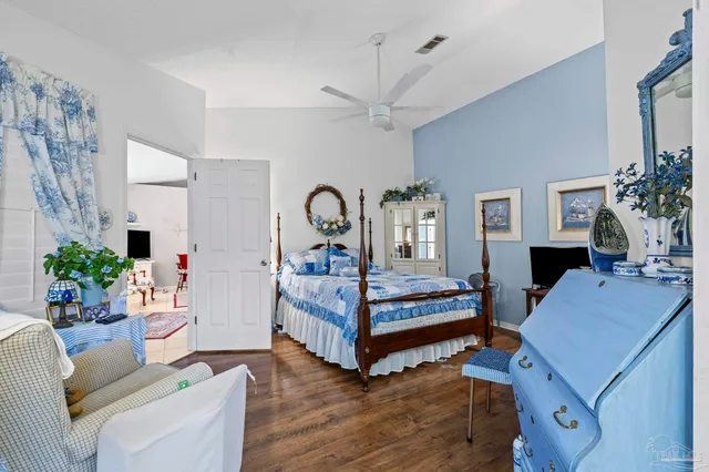 a bedroom with a bed window and a television