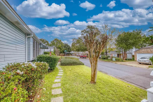 a view of a house with wooden fence