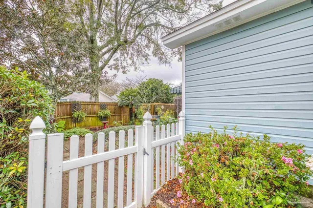 a view of a chair and table in backyard
