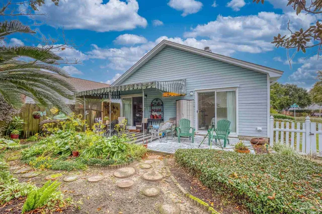 a view of a chair and table in patio of the house