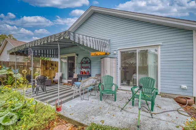 a front view of house with yard and outdoor seating