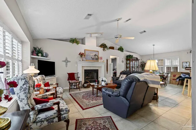 a living room with furniture a window and a flat screen tv