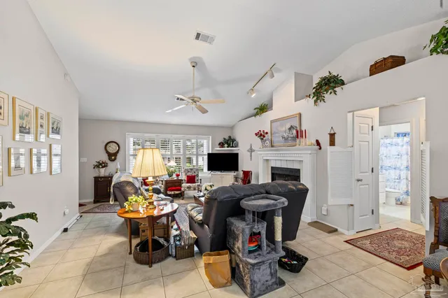 a living room with furniture a fireplace and a flat screen tv