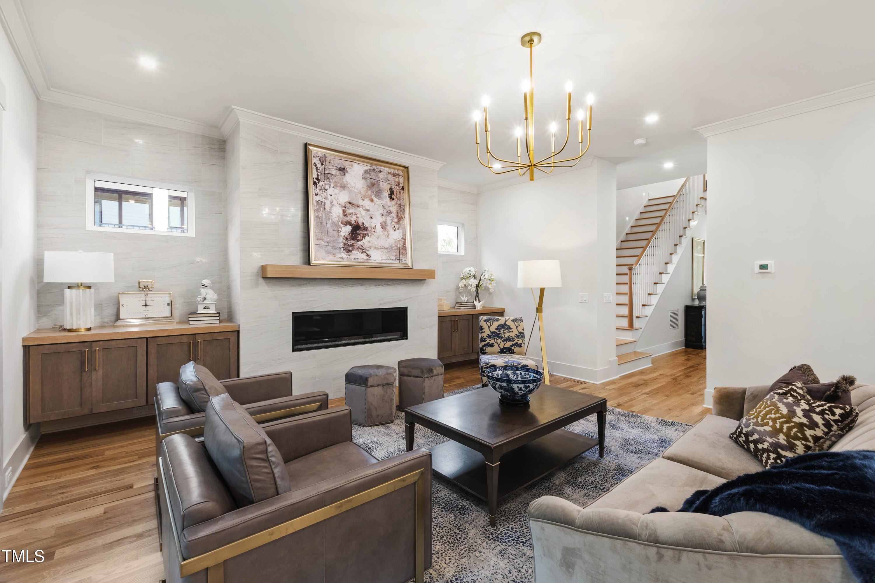 202 Georgetown Road Raleigh, NC 27608 - Photo 12 of 64 a living room with furniture a fireplace and a chandelier